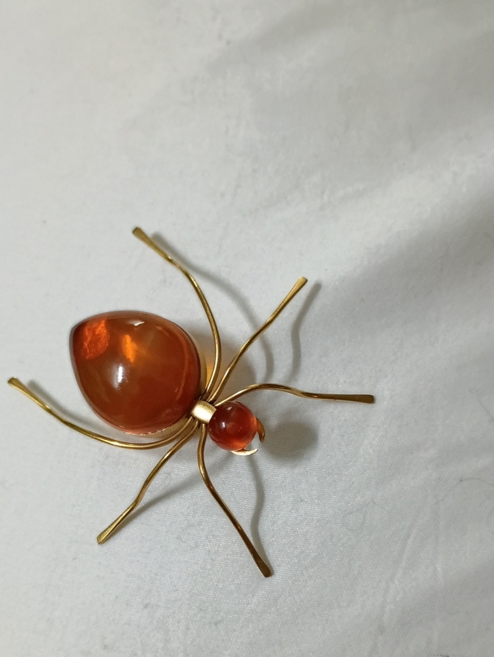 Vintage Soviet-era spider brooch w/ a gold-tone setting w/ Baltic honey amber